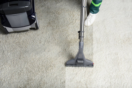 Carpet extraction head cleaning a rug; upholstery detail