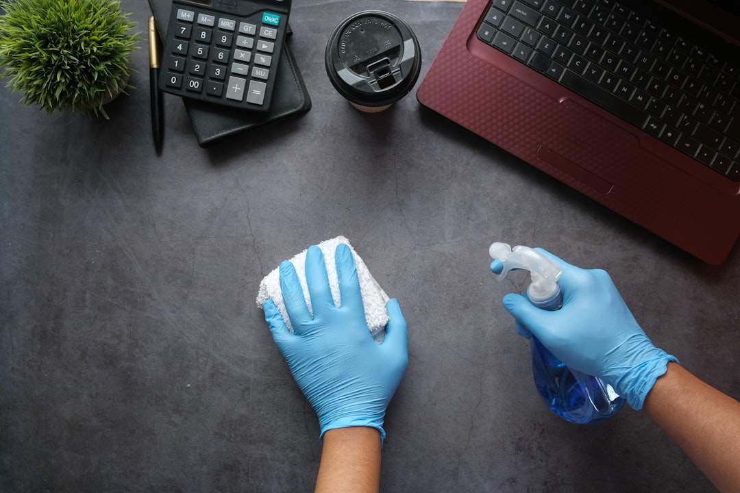 Office cleaning team sanitising desks